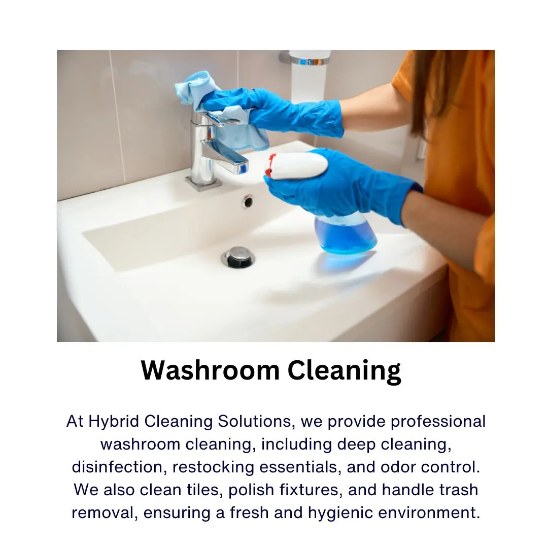 Cleaner scrubbing and disinfecting a bathroom sink in a Birmingham hotel washroom